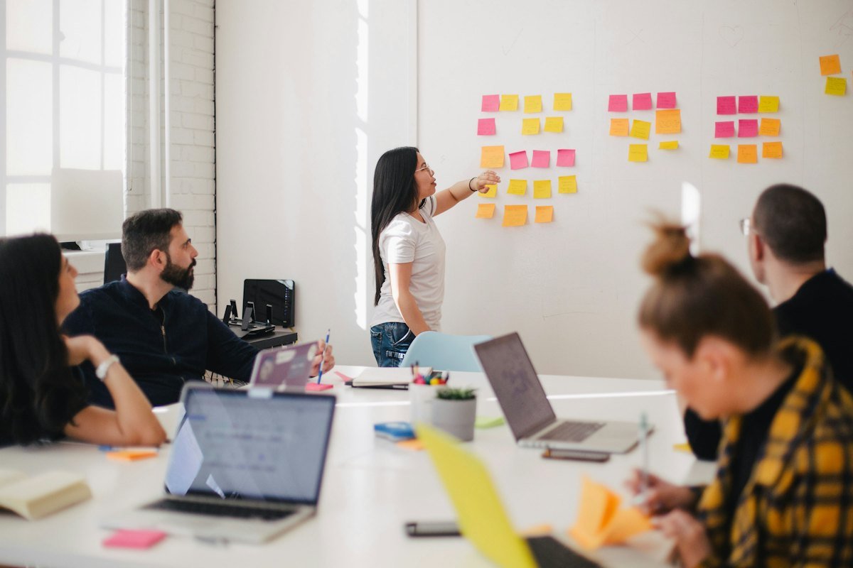 Team planning strategy at a whiteboard